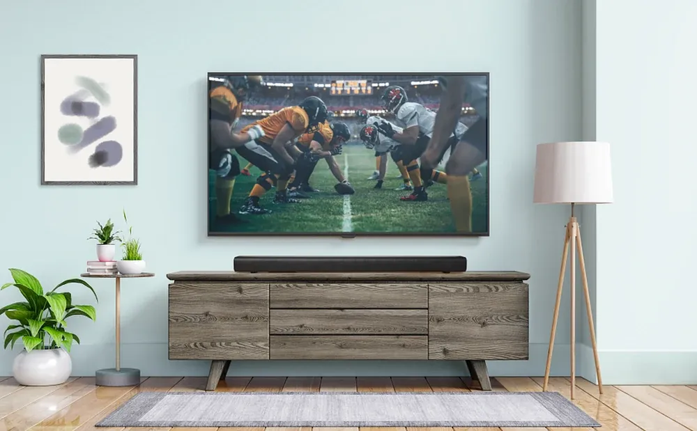 JBL Cinema SB510 sobre un mueble de televisión en un living