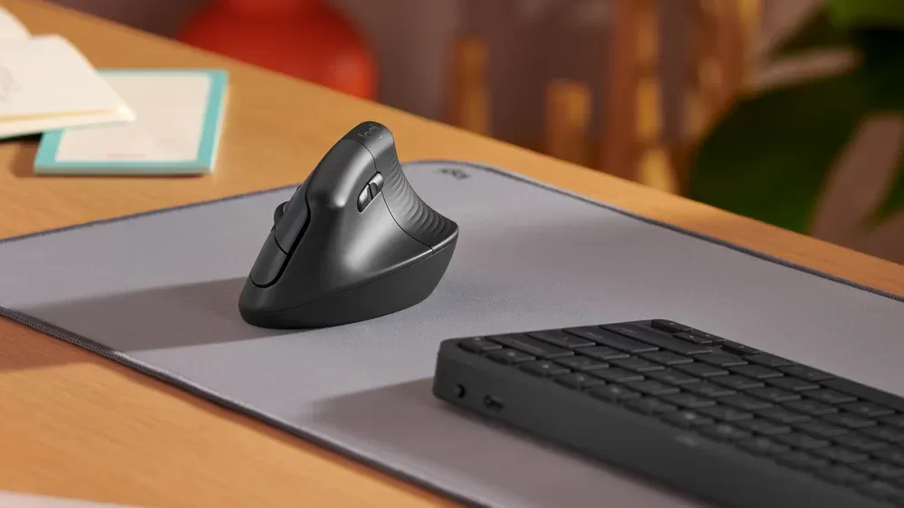 Logitech Lift grafito en un escritorio junto a un teclado